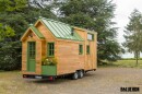 La Mésange Verte
                              features a traditional tiny house exterior
                              and includes a small planter