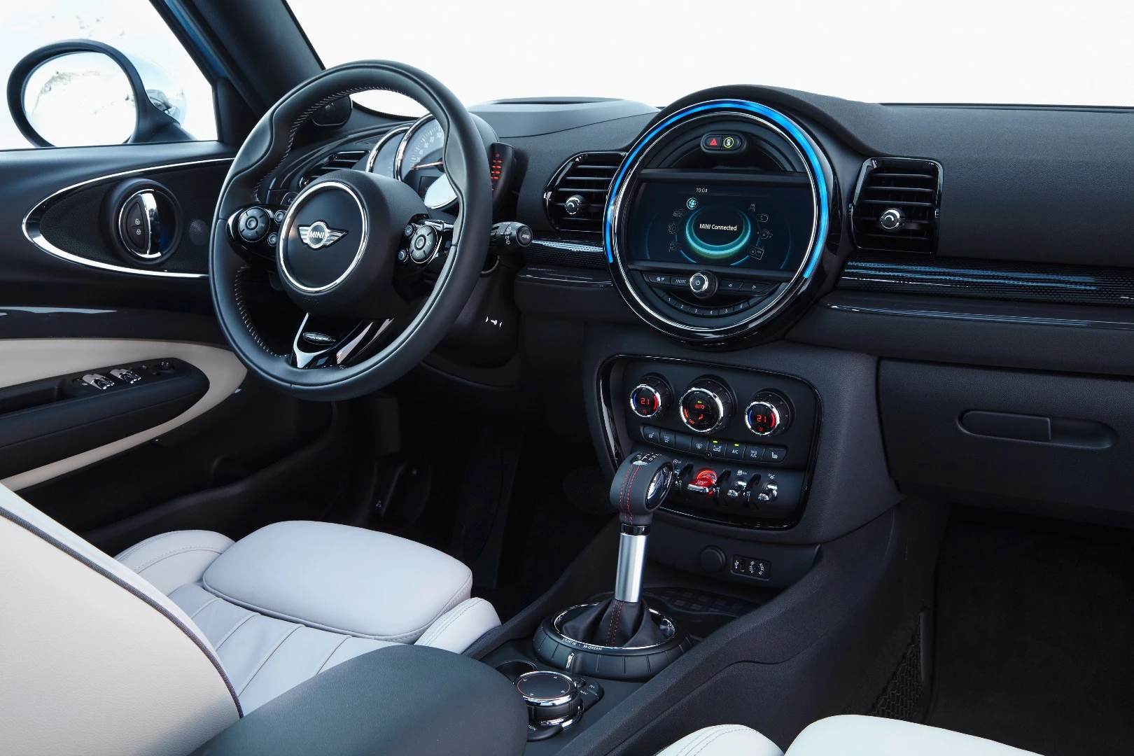 Interior features include the distinctive MINI Connected infotainment system and a head-up display