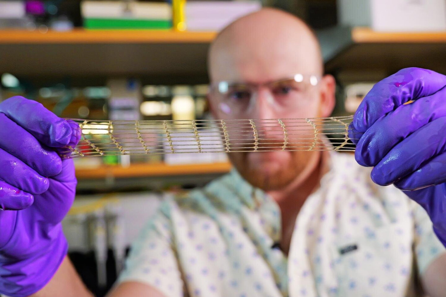 One of the researchers demonstrates that the new hydrogel can stretch impressively without breaking