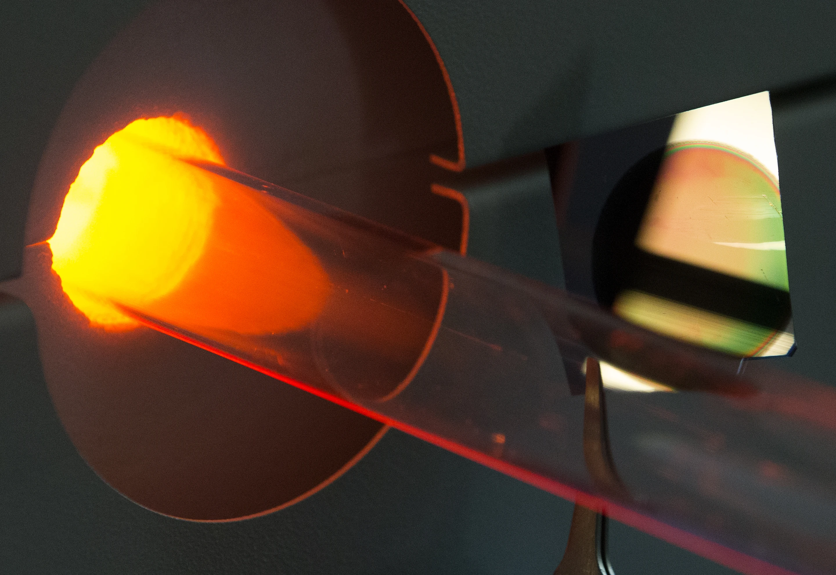 Silicon chip with porous surface next to the special furnace where it was coated with graphene to create a supercapacitor electrode (Joe Howell/Vanderbilt)
