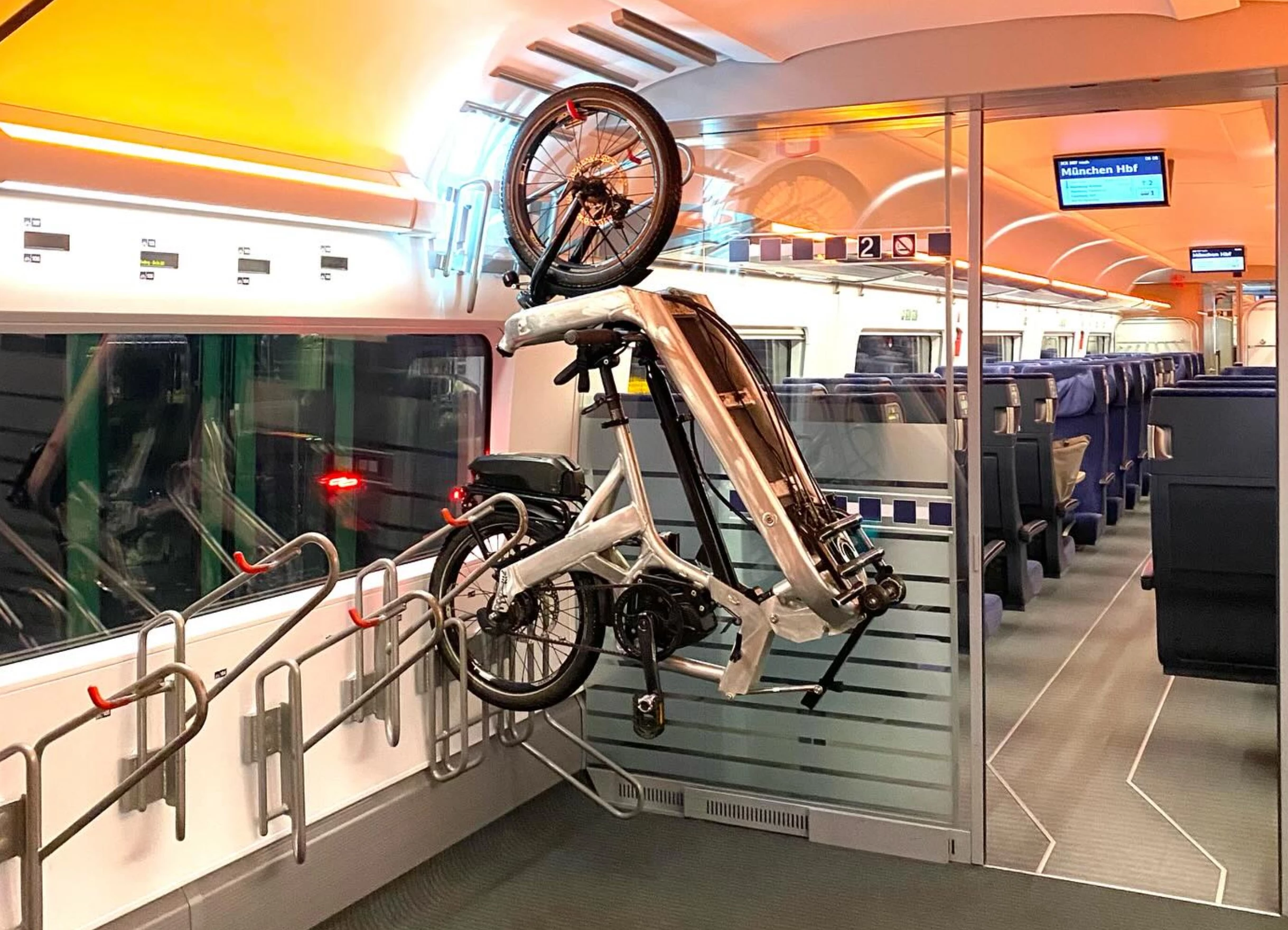 Once folded, the E-Fold Long John cargo e-bike can be secured to the bike rack on the train