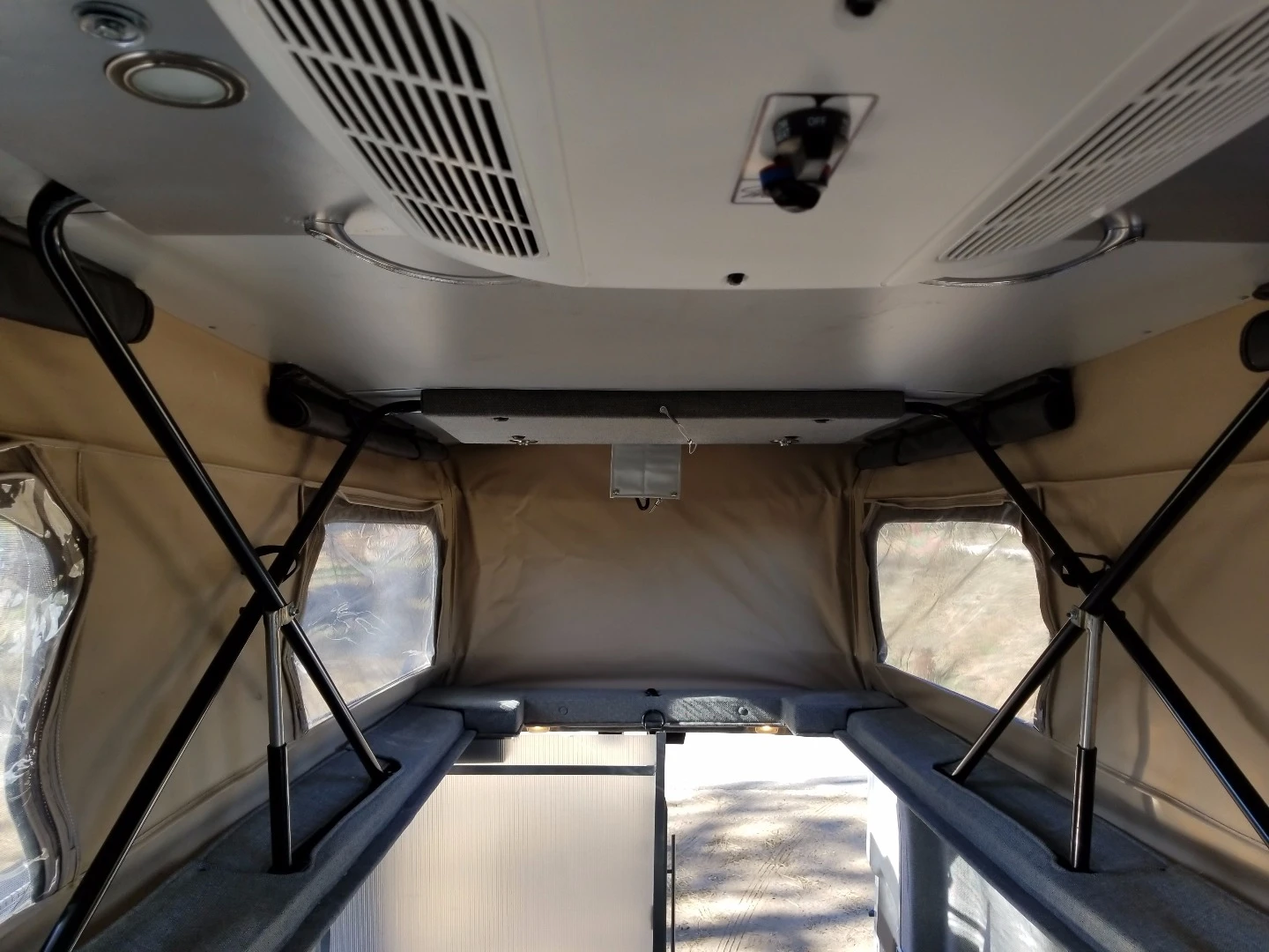 The roof bed moves out of the way to open up standing room in the van