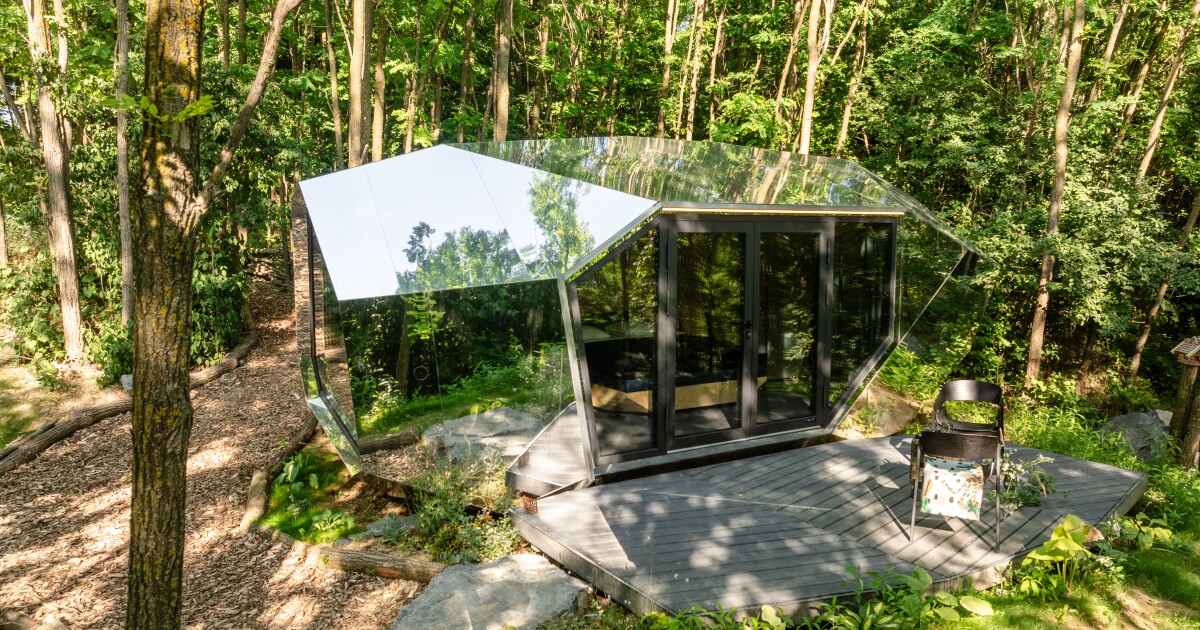 Mirrored tiny house with sauna offers unique design