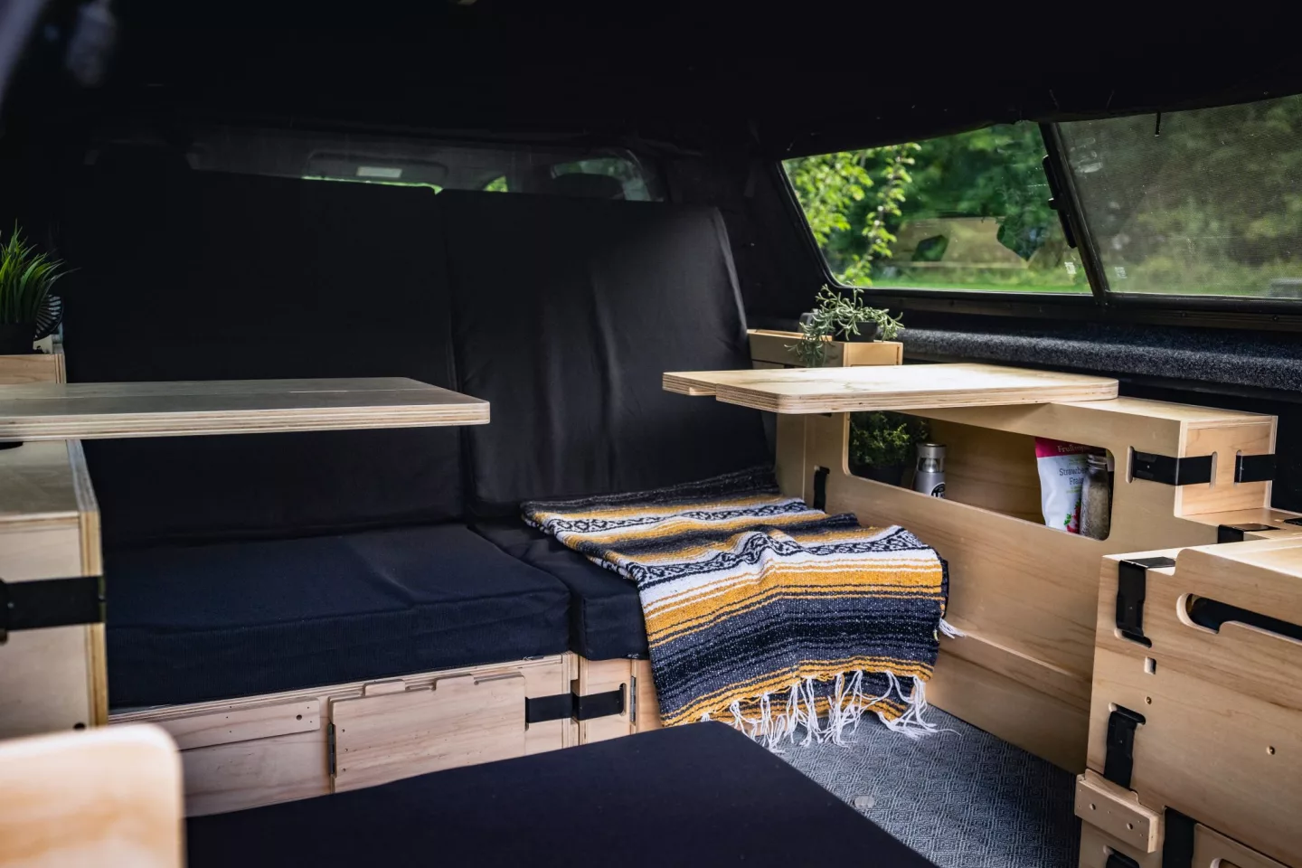 The tables unfold and swing out, providing access to the storage cubbies