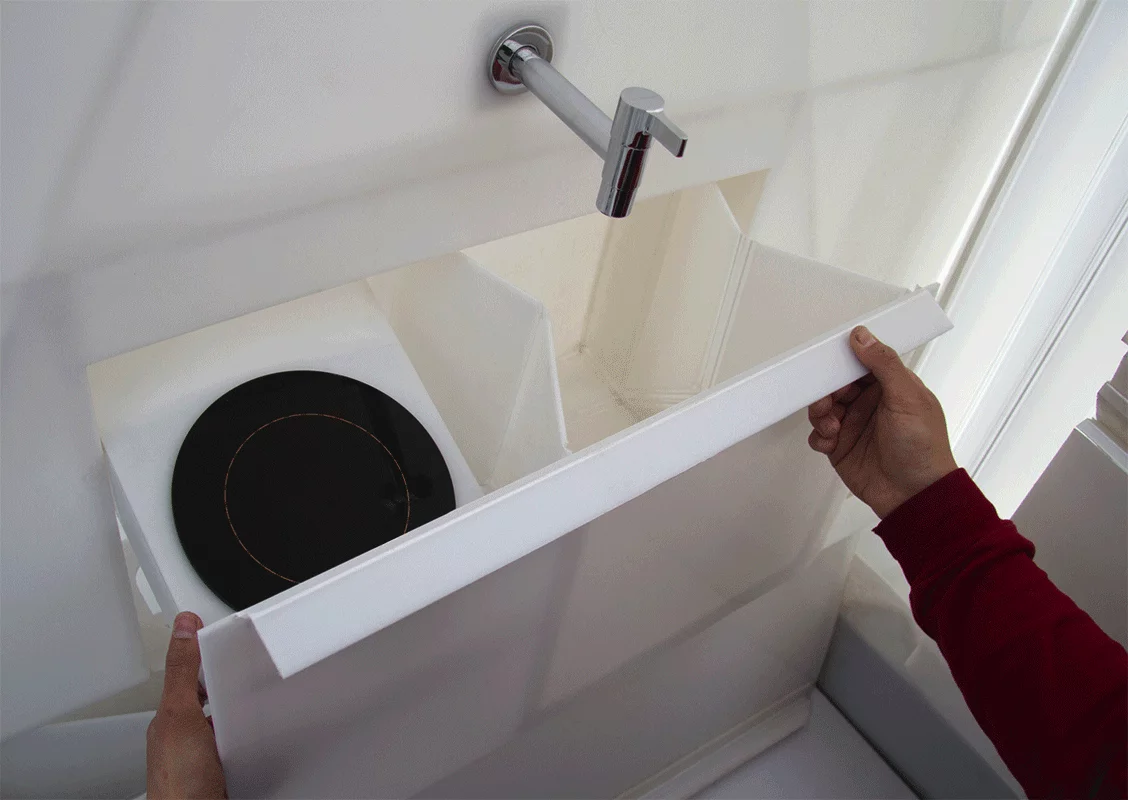 Modern amenities like a bath, bed, and water tank are included