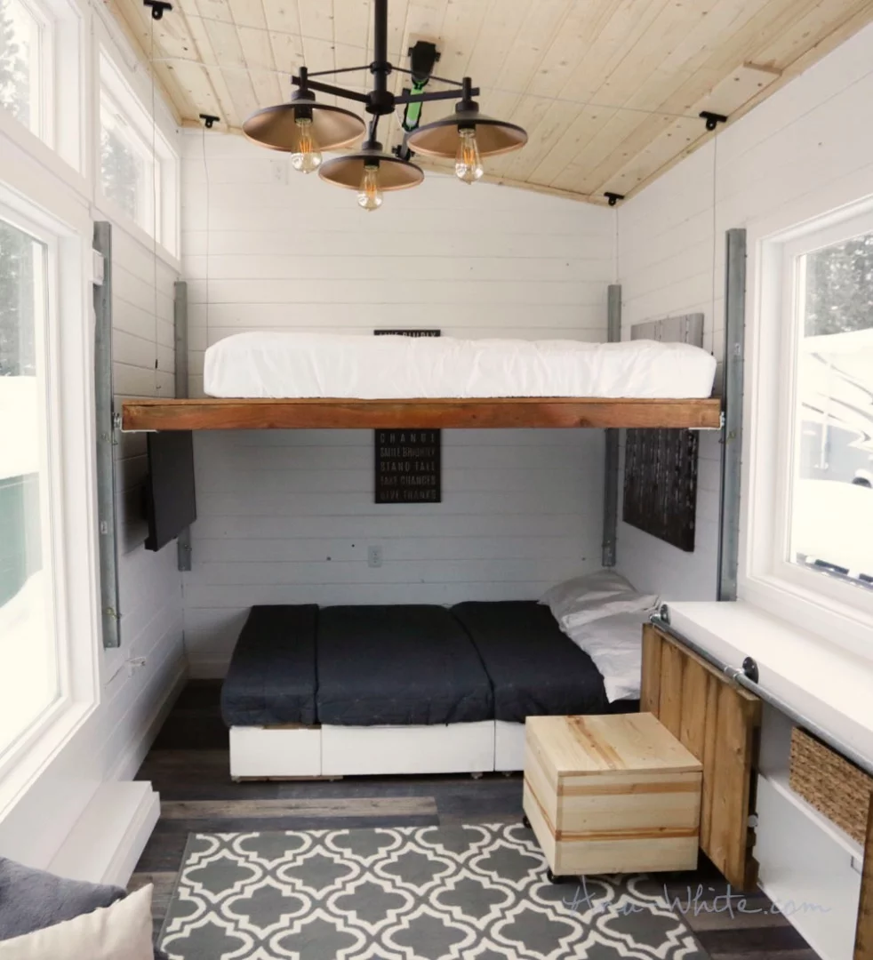 The Open Concept Rustic Modern Tiny House's elevating bed and sofa both ready to be used for sleeping
