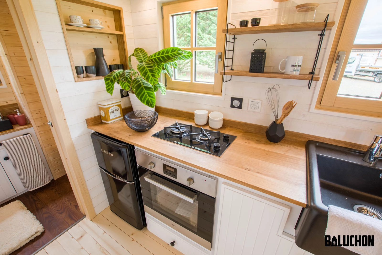 La Mésange Verte's kitchen includes a small fridge/freezer, an oven, and a two-burner propane-powered stove