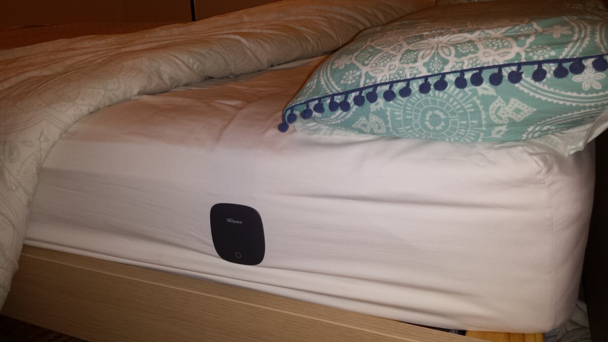 The monitor secures onto the side of your mattress, through the sheet using a magnetic lid