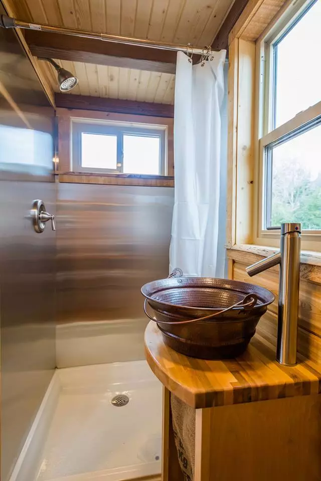 The bathroom in Davis's 22 ft Off-Grid Tiny Home includes a shower, sink, and composting toilet
