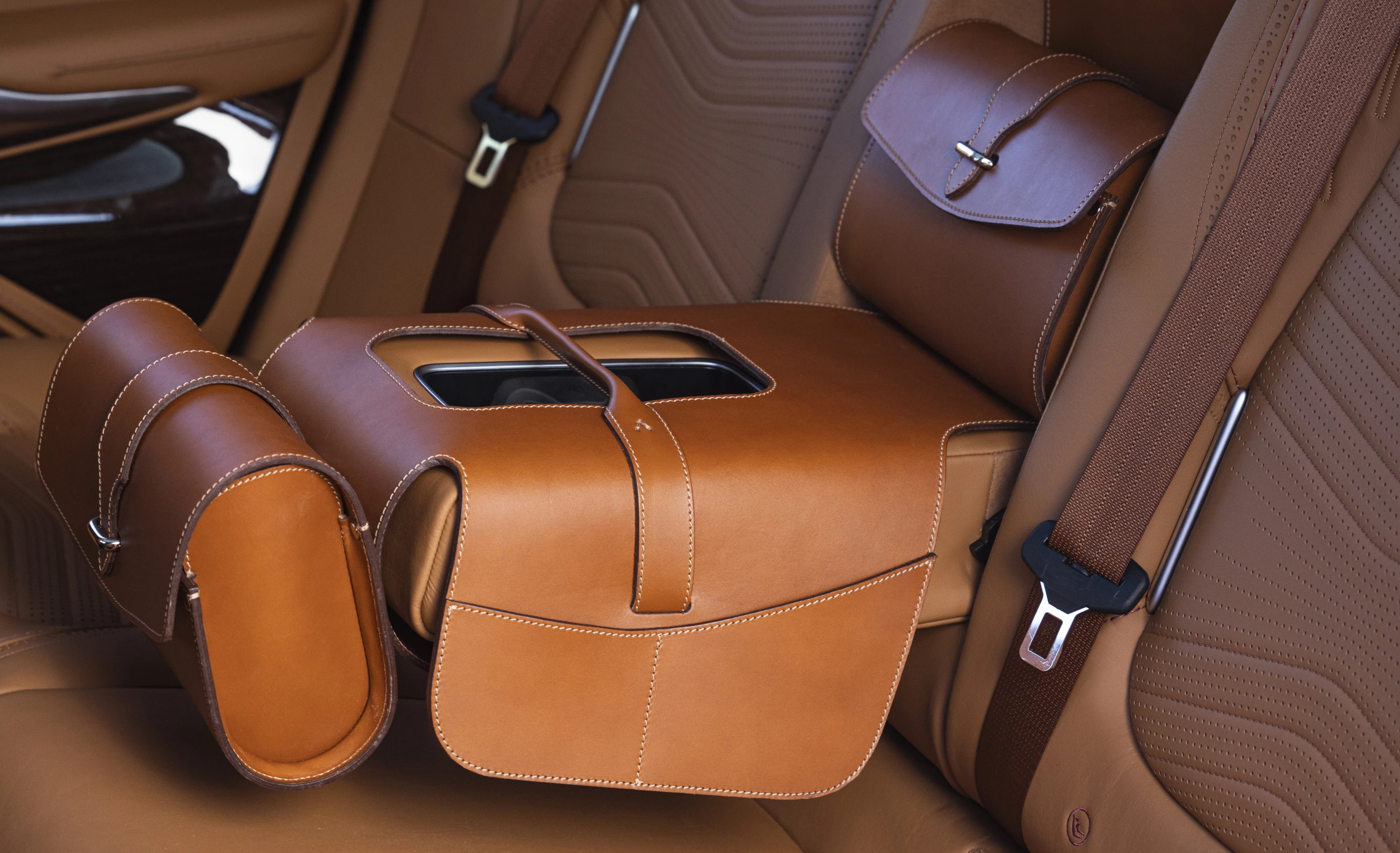 Aston Martin also offers optional leather saddle bags to fit the rear center armrest