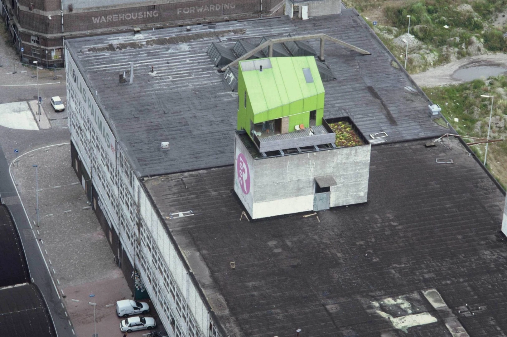 The Green Exhibition House appeared in Rotterdam in 2001, designed as an experiment in assembling a prefabricated structure onto an existing building. In true parasitic fashion, the water pipes, sewage and electricity were all tapped from existing connections in the base building