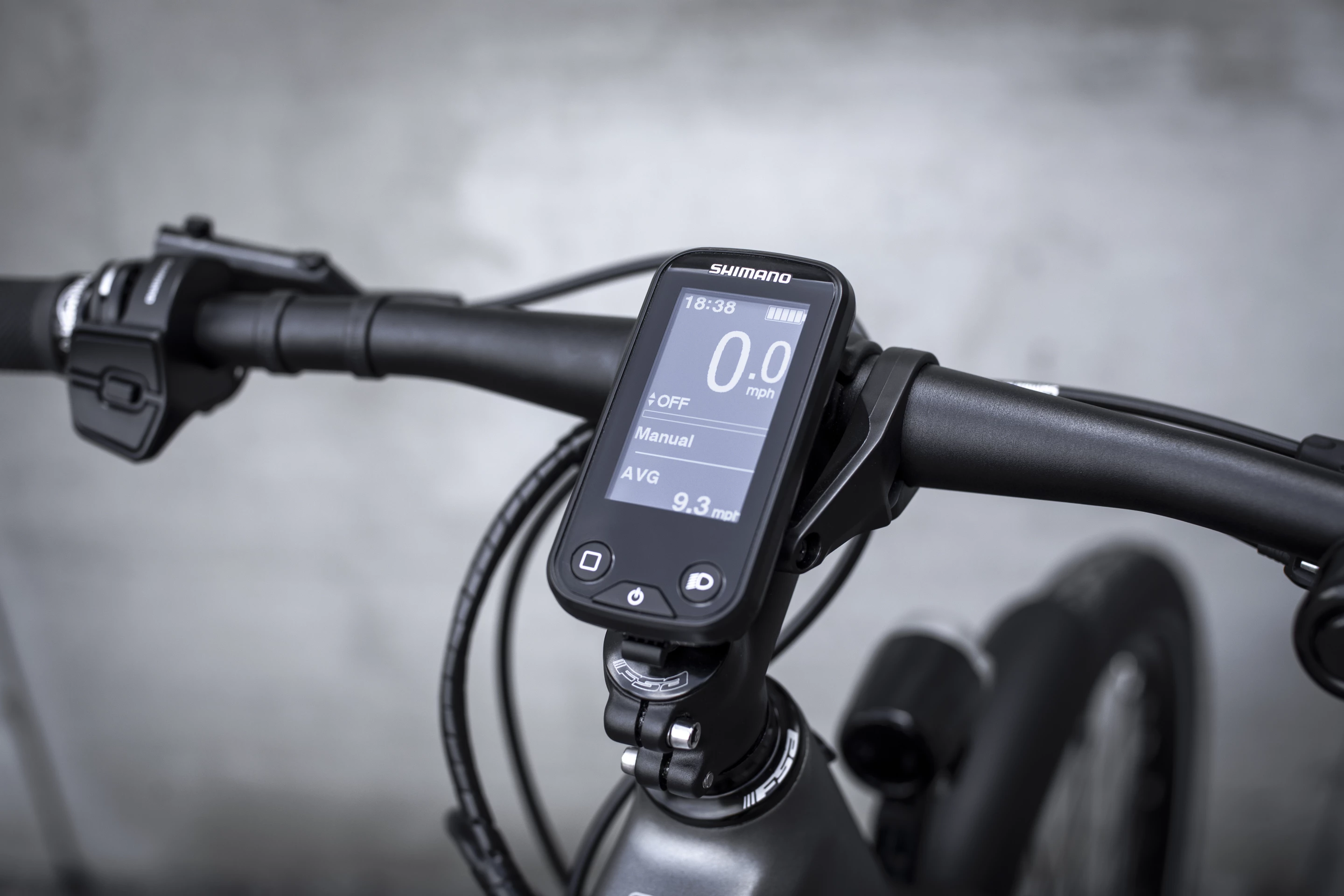 A Shimano display show ride info and sits in the middle of a Triumph narrow-width handlebar