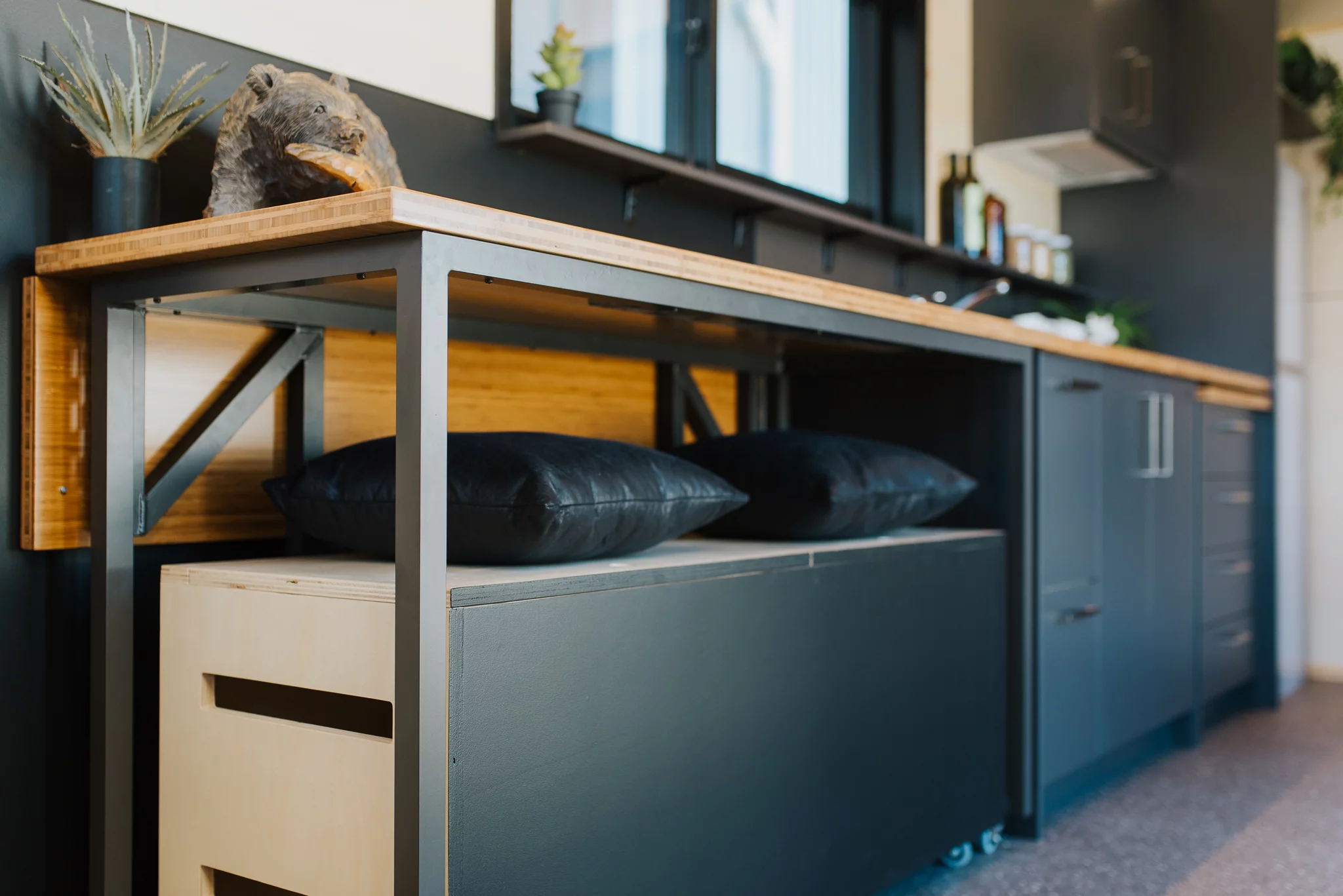 The Tiny Tāwharau features a storage unit on wheels that doubles as a bench