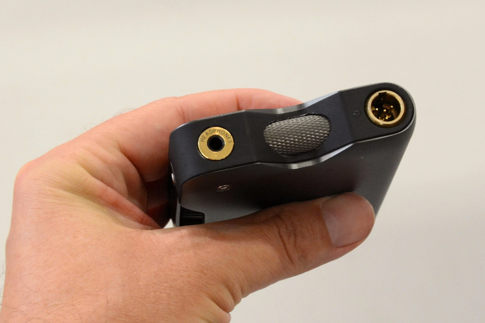 Tp the top, a 3.5 mm headphone jack, a knurled power/volume switch and a mini XLR output port
