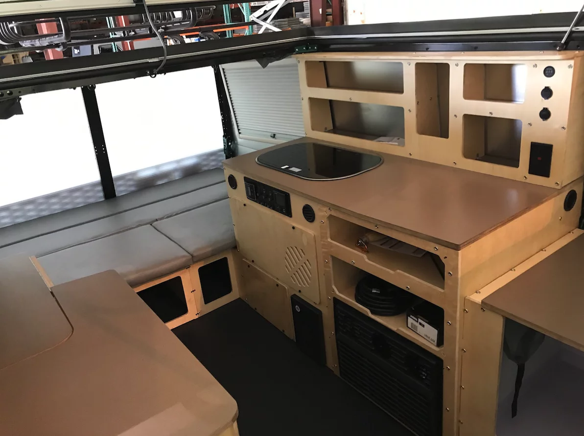 The Mantis includes bunk beds, a full-size bed, a kitchen and a bathroom