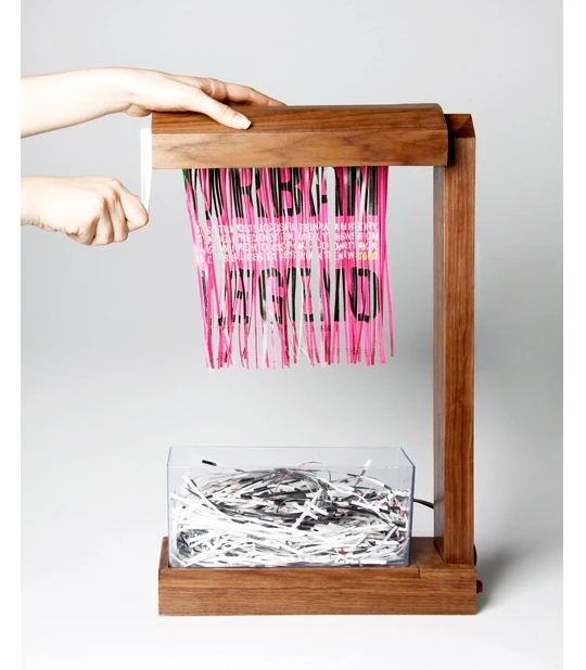 Eliminator is a hand-cranked paper shredder and table lamp in one