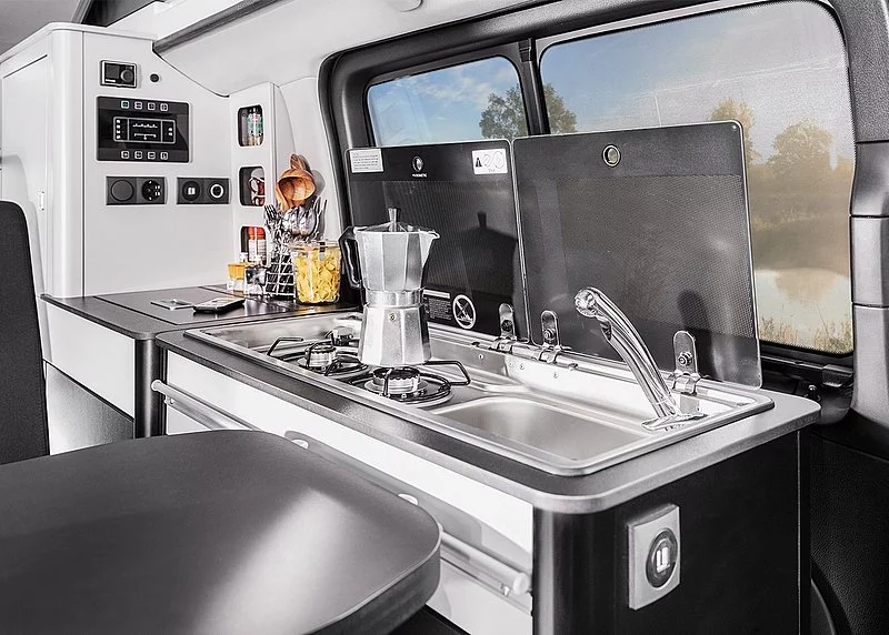 The Base model comes with a fixed kitchen, but the Comfort and Prime models include the indoor/outdoor block