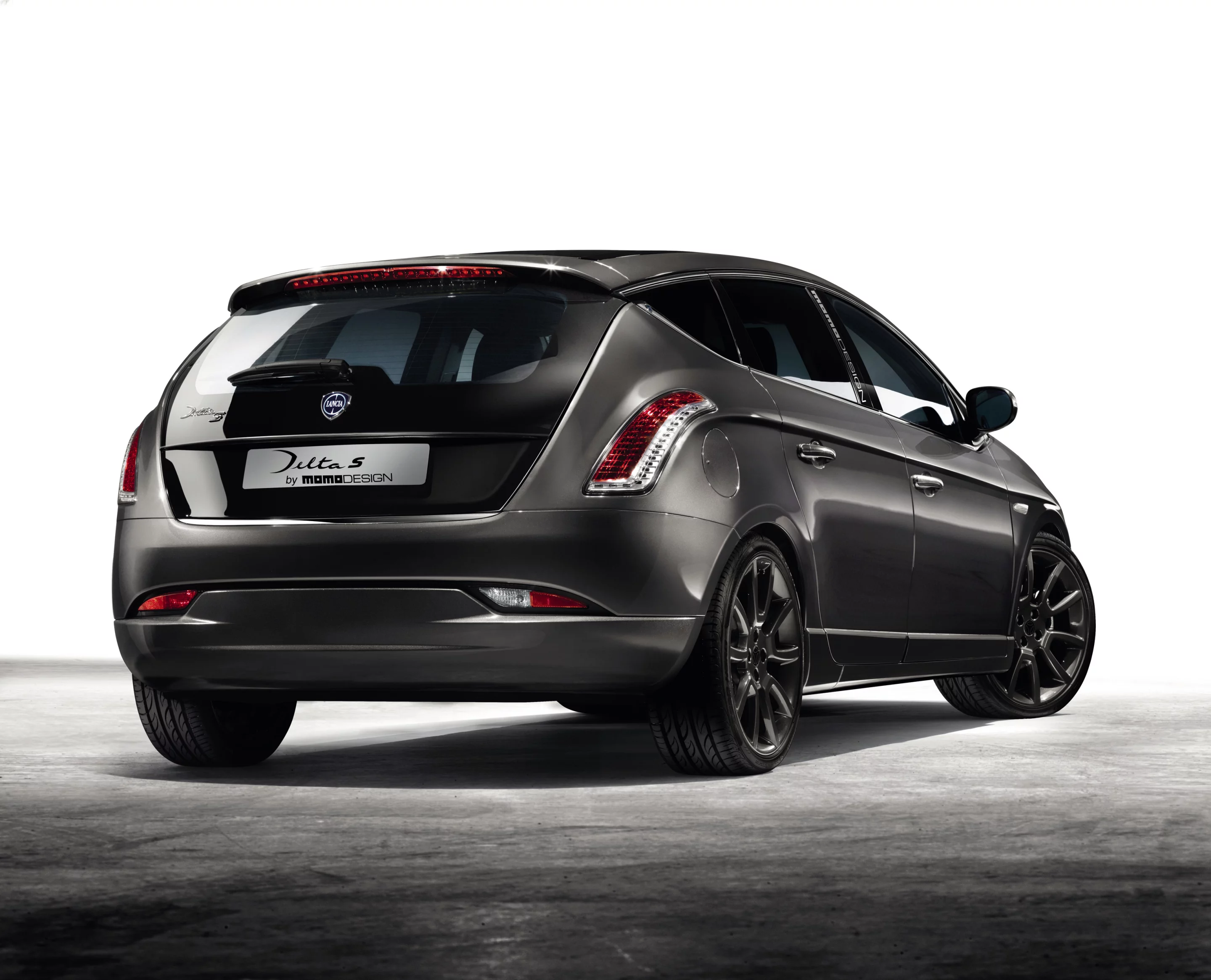 Rear taillights curve up and over the rear fender, blending into the descending waistline treatment that brackets the narrowed hatch