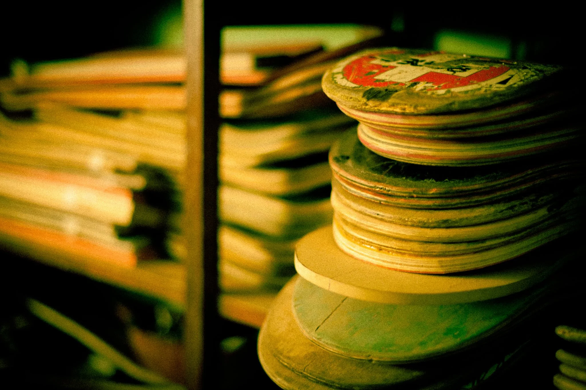 Stacks and stacks of old skateboards about to become Skate Guitars