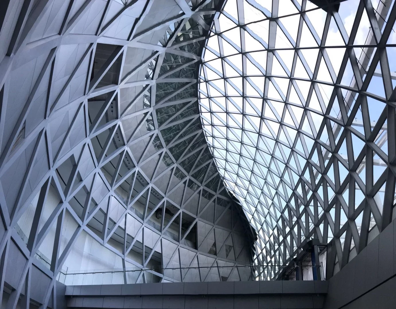 Jewel Changi Airport's rainwater-fed Rain Vortex will shower rainwater from a central oculus seven stories down down