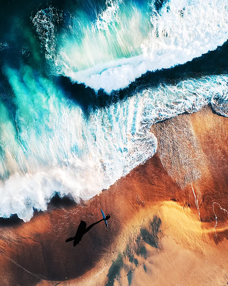 Winner of 1st place in the Professional Seascape category: Emily Kaszton - Wave Rider. A surfer approaching the roaring waves