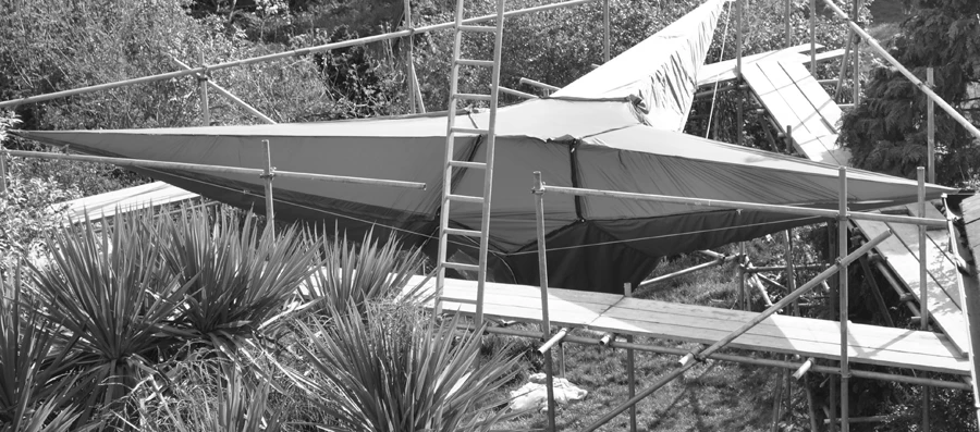 The frame is held in tension by elongates which collect at each of the three high level anchor points