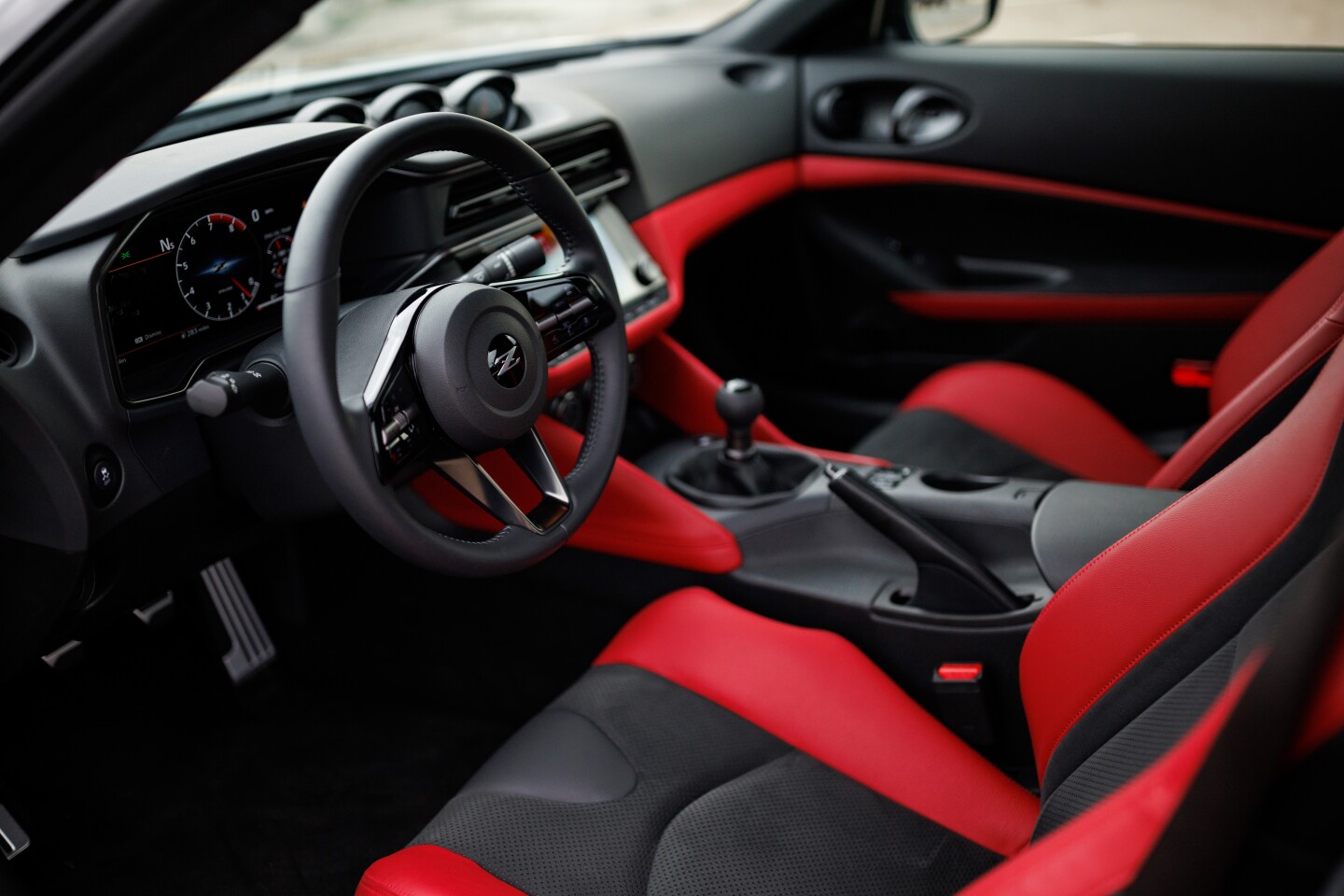The optional red on black interior, shown here with the manual transmission, is a beautiful mix of color