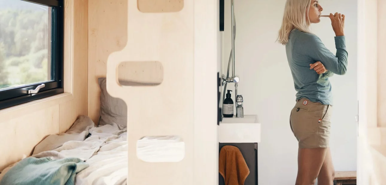 A set of timber single bunk beds have been built into the structure of the interior