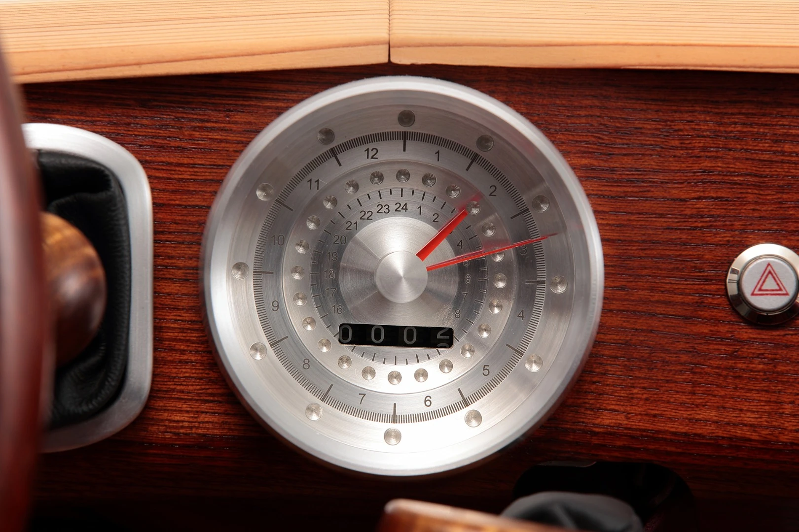 The radial clock/meter inside the car sits on the dashboard and ticks away the time over a 100 year span