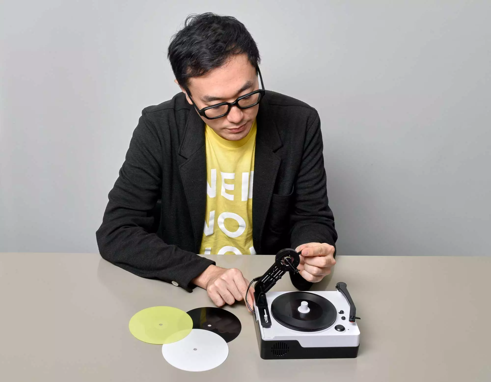 Designer Yuri Suzuki with the Instant Record Cutting Machine