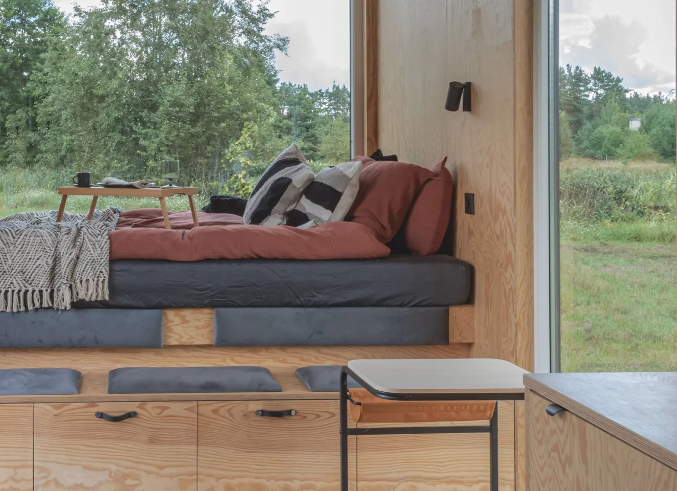The BTH Loft off-grid's living area doubles as the home's downstairs sleeping area