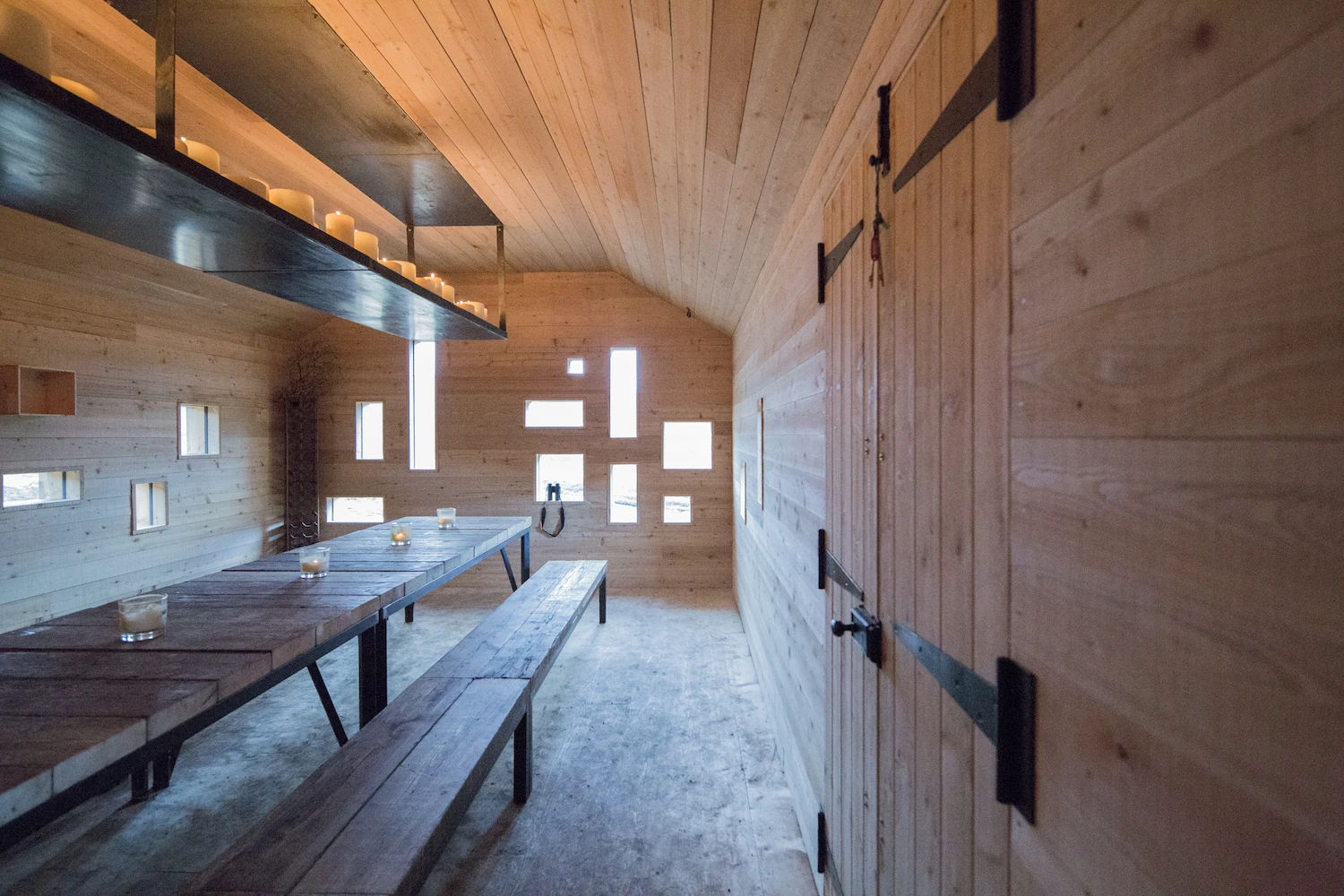 A large dining table dominates the interior of the Culardoch Shieling
