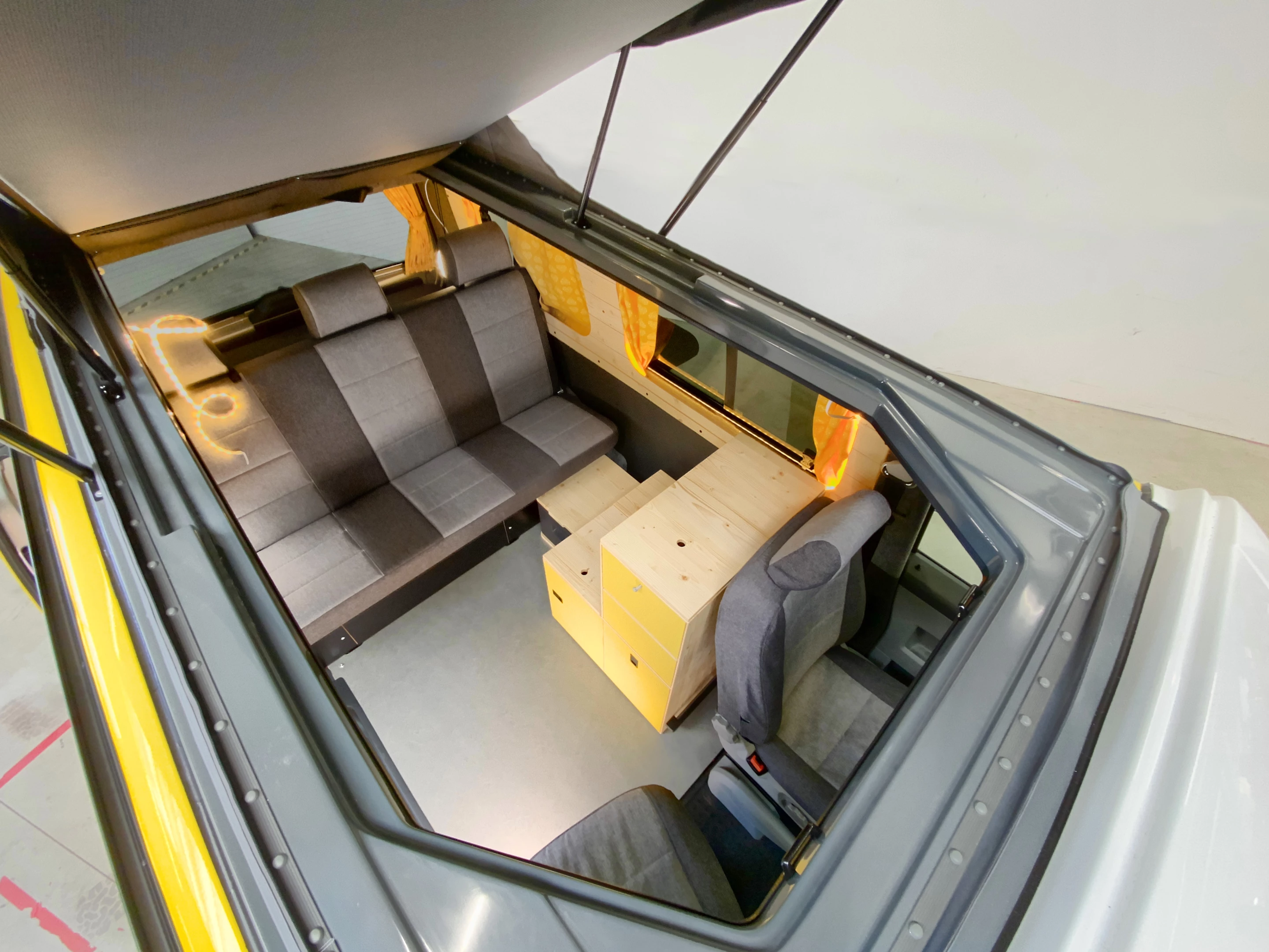 The Frieda Volt shares a floor plan with the older Frieda model, including a folding three-seat bench/bed and a stack of kitchen boxes/cabinets