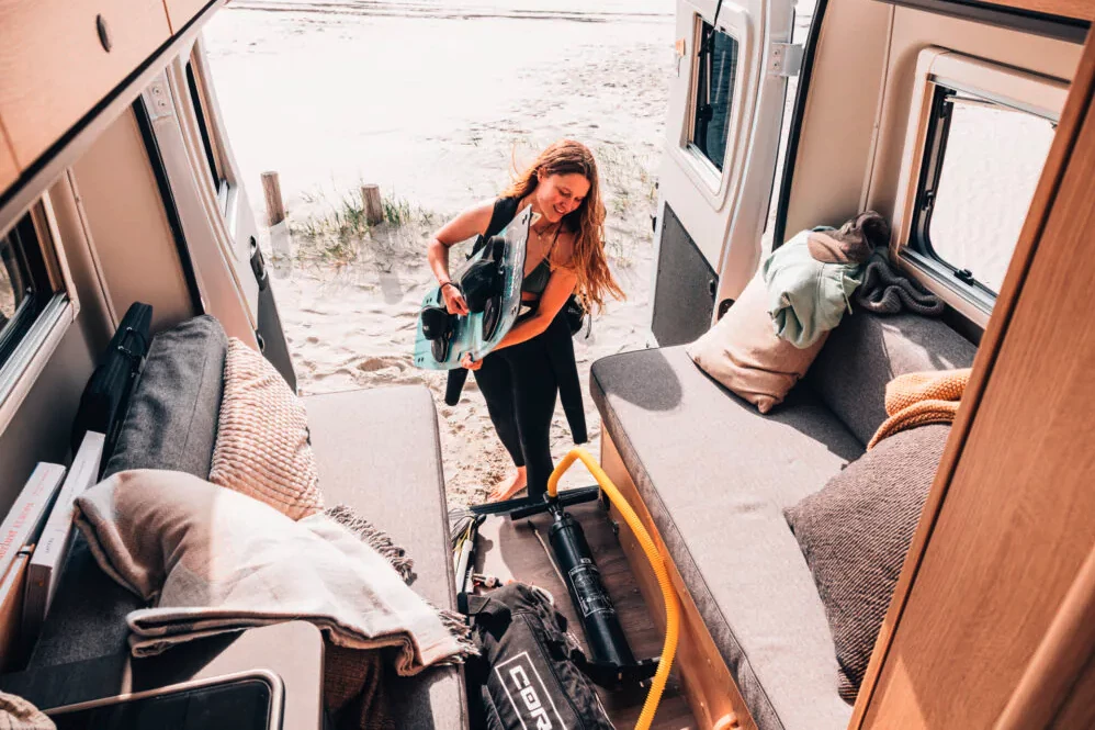The dining table collapses so Vanlifers can utilize the long center aisle for storing gear