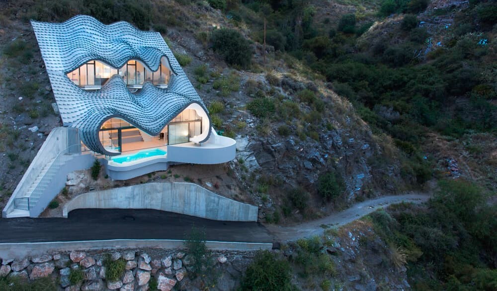Also inspired by Spanish architectural giant Antoni Gaudí, the home is built into the cliff to cut down on cooling requirements