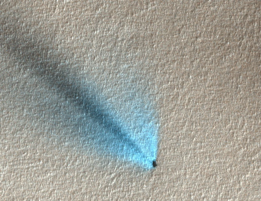 An unusual fan, light rather than dark, thought to be caused by carbon dioxide gas escaping from under the ice recondensing into frost