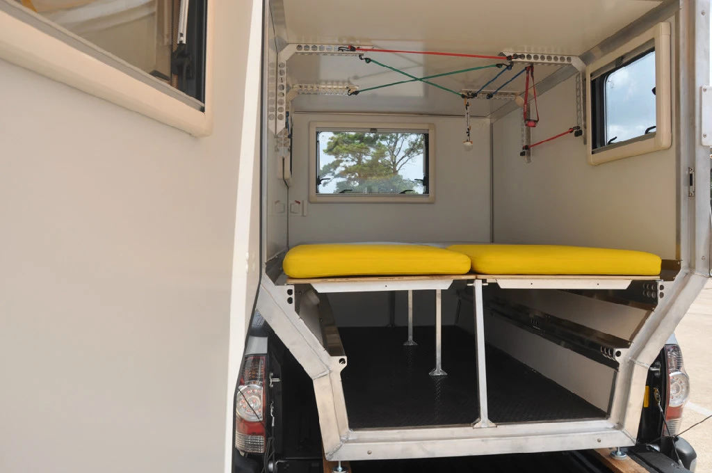 In addition to its bed, the interior has a variety of straps and lash points