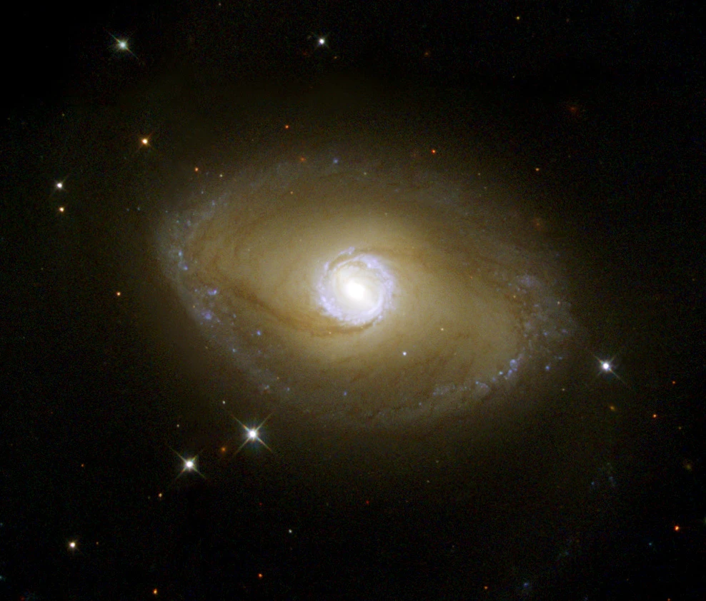 This spiral galaxy, when seen in visible light, exhibits tightly wound spiral arms that give it a pinwheel shape similar to that of many other spirals. However, when the galaxy is viewed in ultraviolet light with NASA/ESA Hubble Space Telescope, its shape is startlingly different