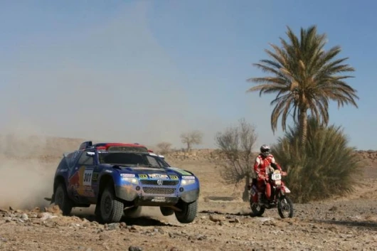 Saby passing a motorcycle in the desert