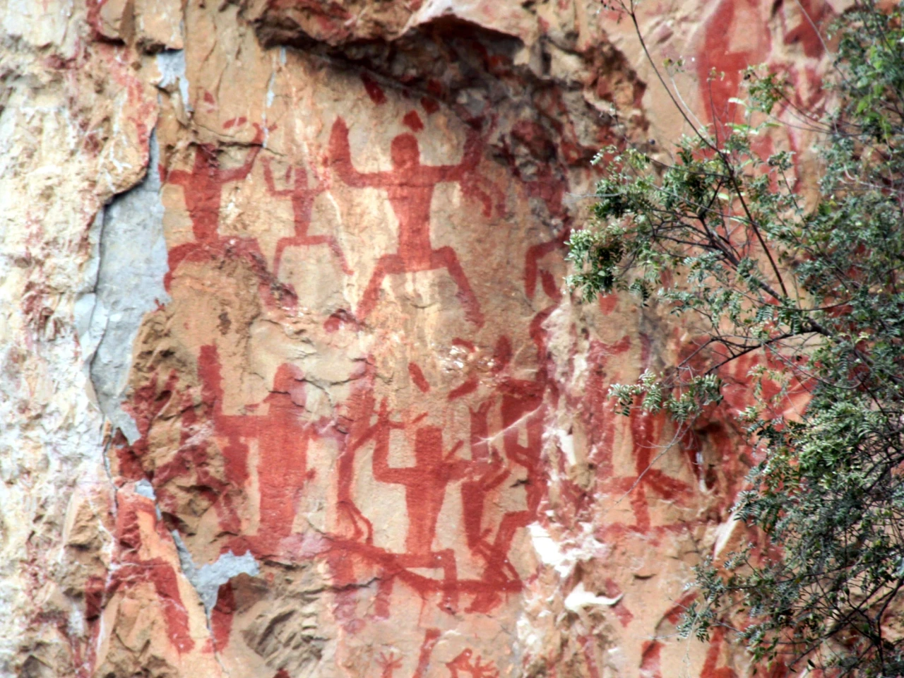 Red figures painted on a cliff face