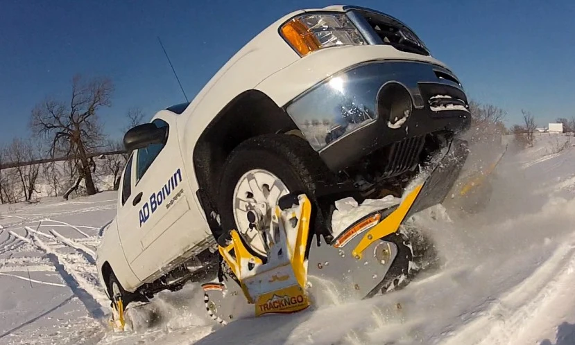 Ski-like deflector plates on each track help it to ride up on top of snow instead of diving into it