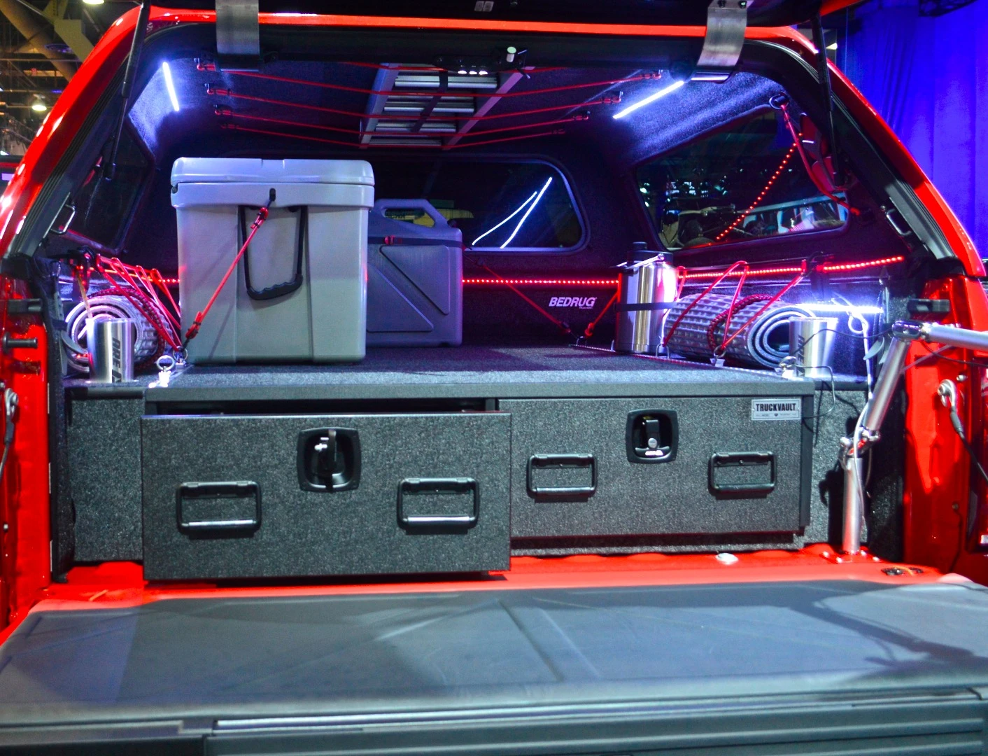 The F-150 Modern Adventurer includes an A.R.E. bed cap and TruckVault storage drawers, along with a James Baroud roof-top tent