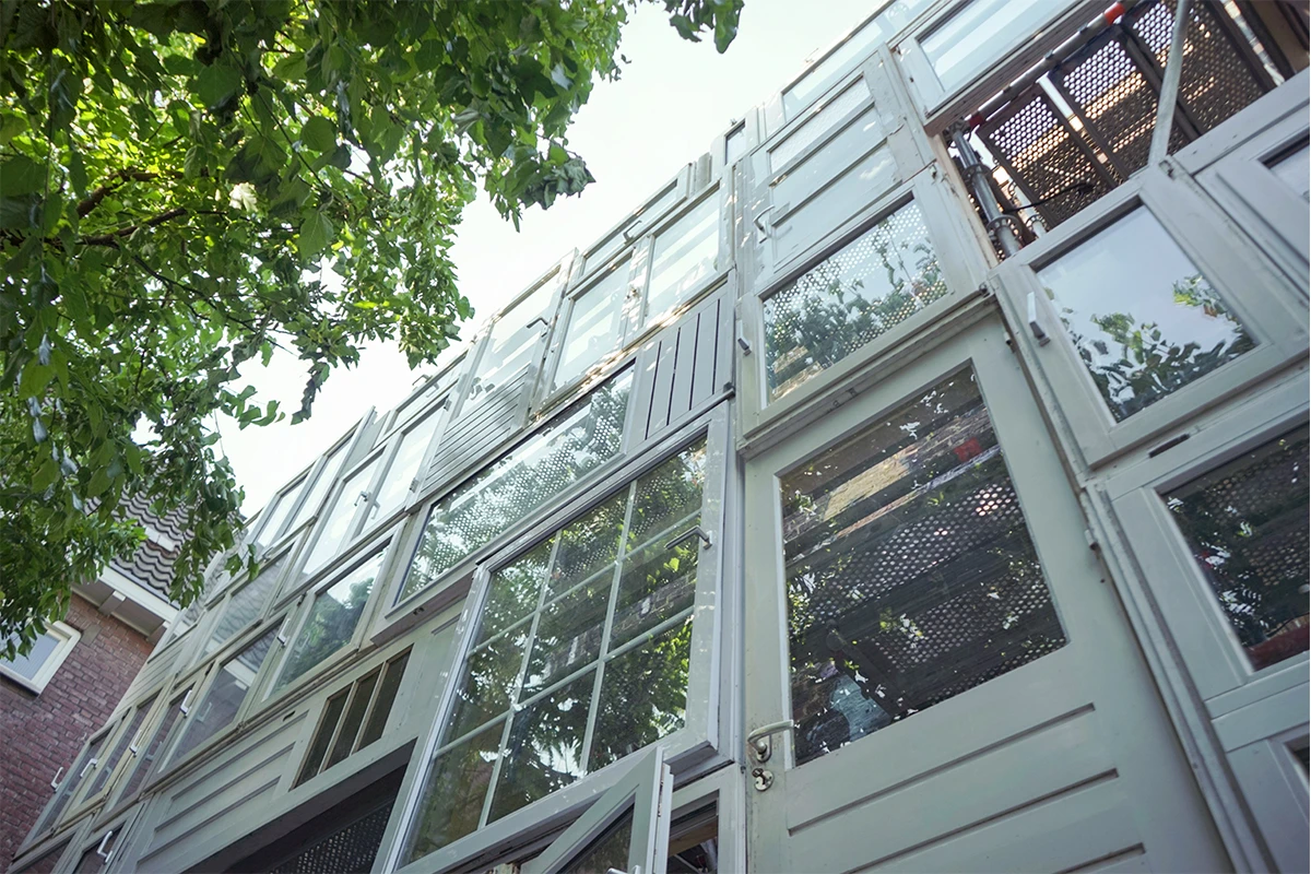 The two-story structure is built from a collection of salvaged windows and doors (Photo: Laurent Clement)