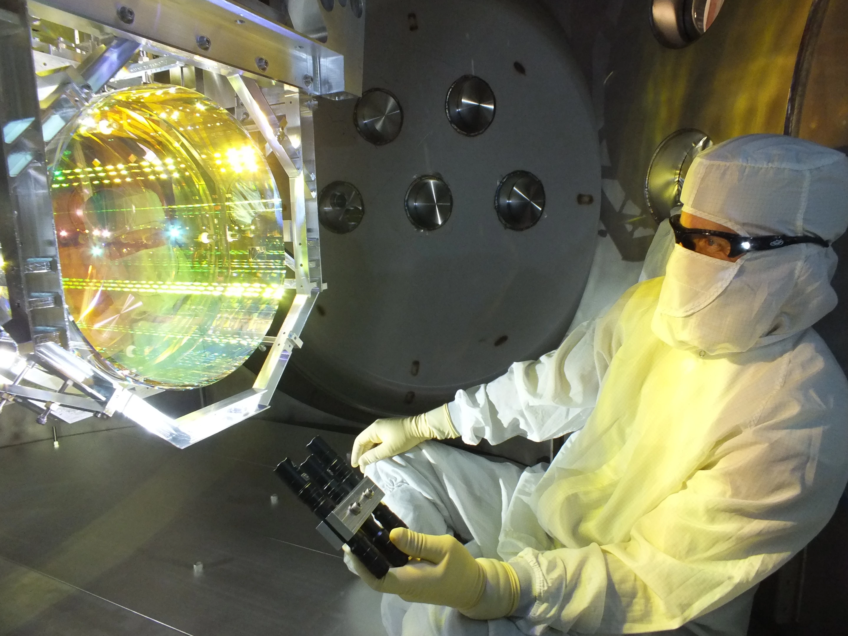 A scientist inspecting one of LIGO's mirrors, which has now been measurably affected by quantum fluctuations