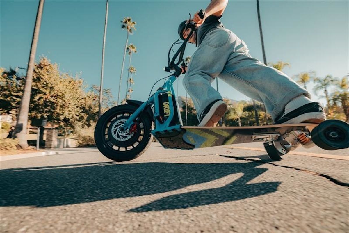 At the rear of the deck is a skateboard truck with independent suspension plus a caster wheel to help with drifts and slides