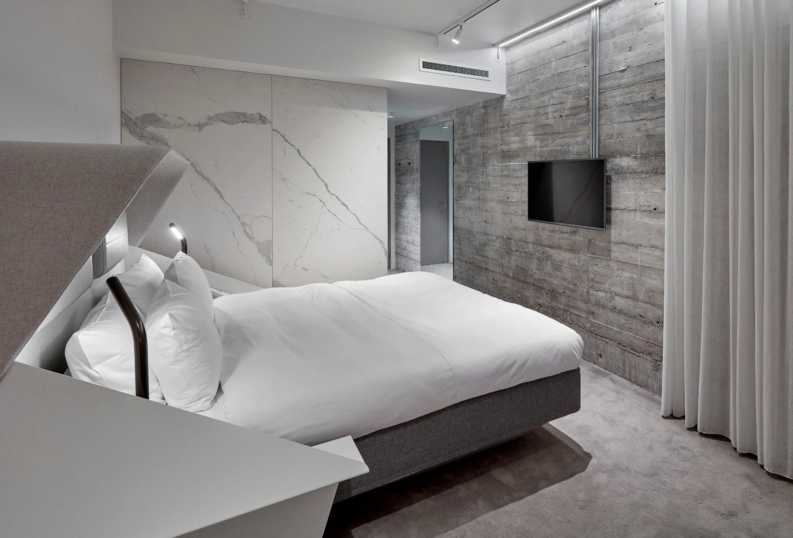 The industrial theme of the Hotel Herman K continues indoors with exposed concrete surfaces