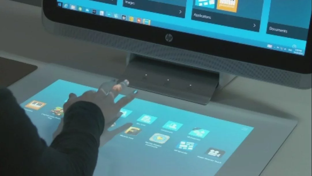 A second screen is projected down onto a 20-inch, 20-point capacitive touch mat