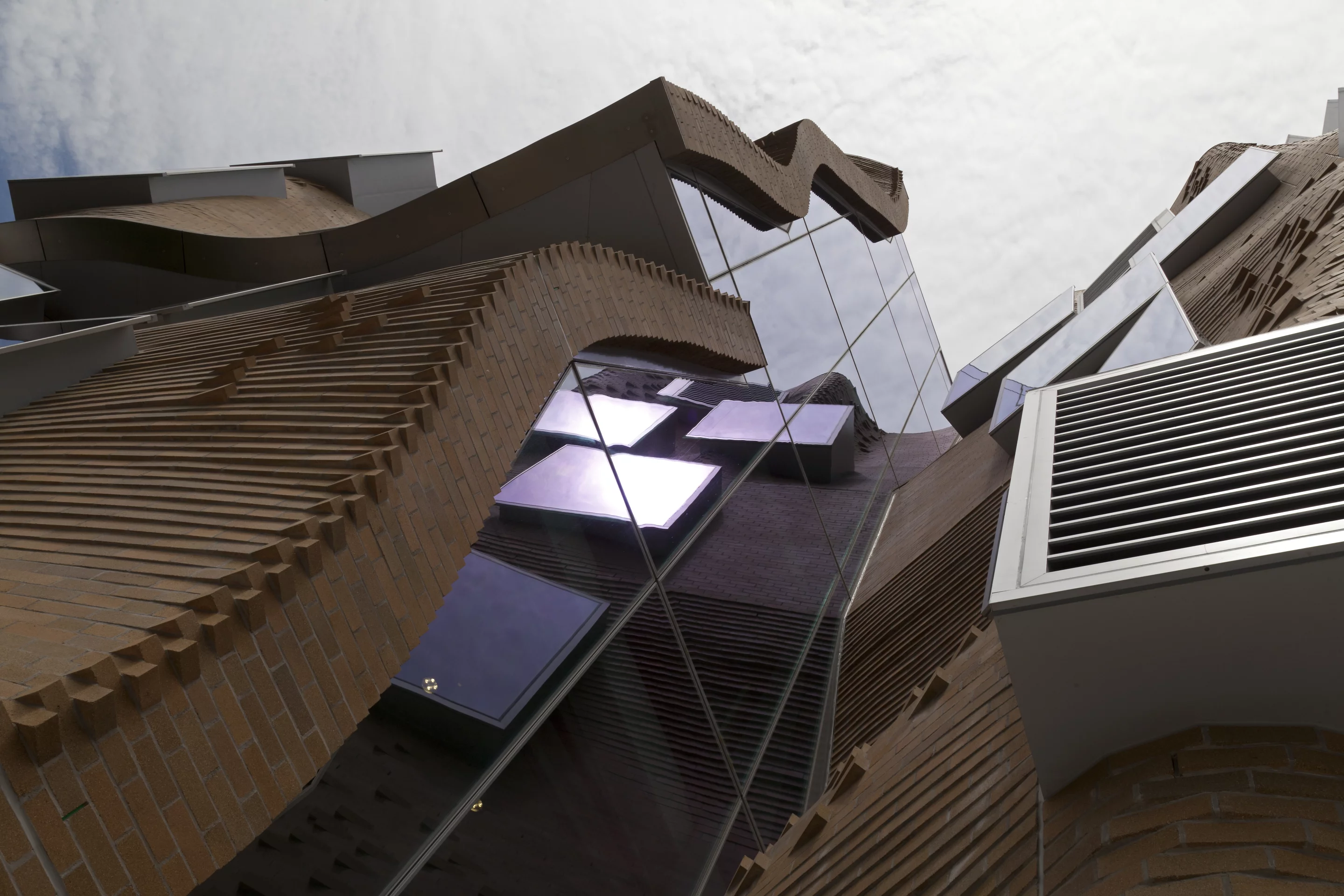 The most striking feature of the building is its east-facing sandstone colored, undulating facade (Photo: Andrew Worssam)