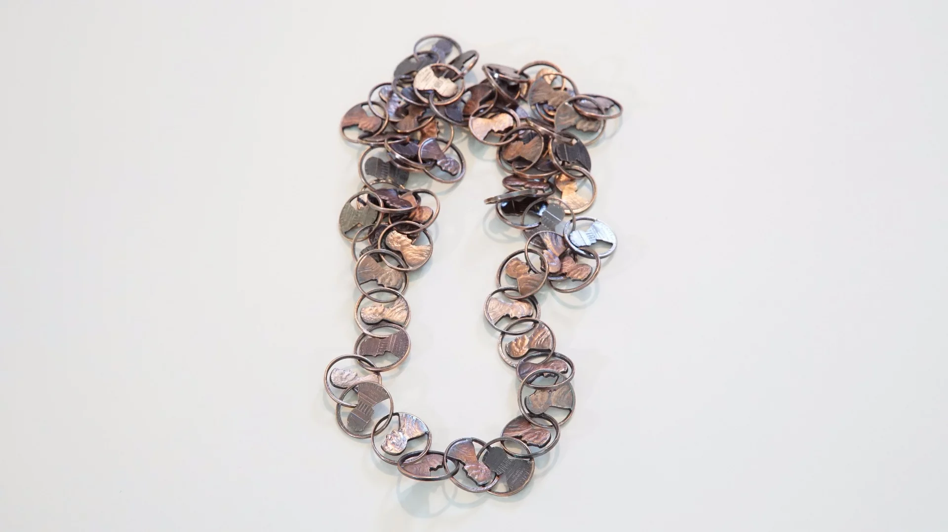 A finished necklace featuring pennies cut using the Wazer waterjet cutter