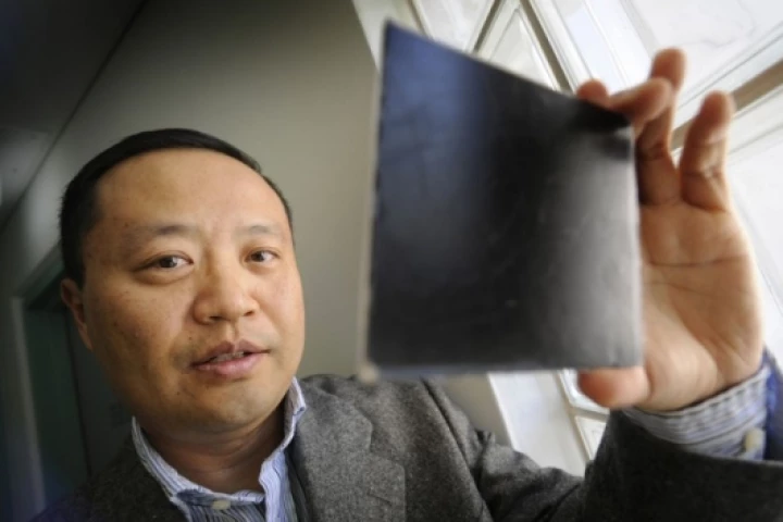 Dr Chan inspecting a small piece of the nanocomposite material.